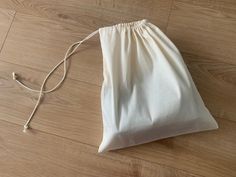 a white bag sitting on top of a wooden floor