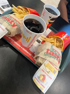 a tray with fries, ketchup and french fries on it sitting on a table