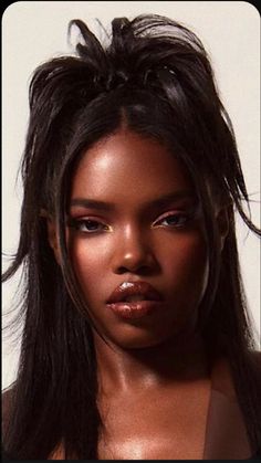 a close up of a woman with long hair wearing a brown dress and piercings