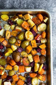 roasted vegetables in a baking pan on a table