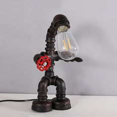 a lamp that is shaped like a robot with a light bulb on it's head