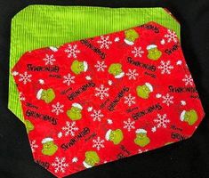 two neck ties on top of each other in red and green with snowflakes