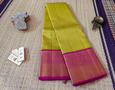 This gorgeous Lime Green Pure Kanjivaram Handloom Silk Saree with elegant plain body. Also, the border has beautiful floral pattern in golden zari, while the pallu features again a geometric pattern. About Kanjivaram / Kanchipuram Silks Kanjivaram or Kanchipuram sarees are believed to be the silk of the goddess. The feel, the fabric, the craftsmanship and the weave of these handloom sarees are just exquisite. Kanjivaram takes highly skilled artisans who are weaving these gorgeous sarees from gen Gold Saree With Traditional Patterns In Tissue Silk, Transitional Gold Saree With Traditional Patterns, Gold Tissue Silk Dupatta With Border, Gold Raw Silk Saree With Border Detail, Gold Raw Silk Saree With Border, Gold Saree With Border For Traditional Ceremonies, Gold Traditional Wear With Border For Puja, Gold Saree With Border For Diwali, Gold Traditional Wear With Border For Diwali