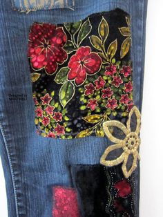 the back pocket of a pair of jeans with embroidered flowers on them and sequins