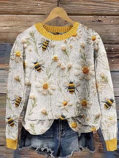 a sweater with bees and flowers on it