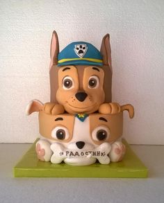 a toy dog with two smaller dogs on top of it's back legs and head