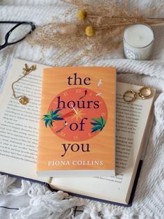 the hours of you by fionna collins on top of an open book