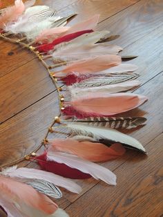 a necklace made out of feathers on a wooden floor