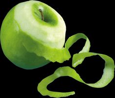 an apple that has been cut in half and is sitting on a black surface with the peel still attached