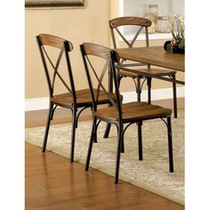 a dining room table with four chairs and a rug