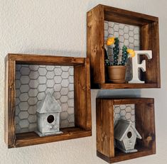 two wooden shelves with bird houses and flowers