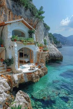 a house built into the side of a cliff by the ocean