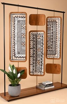 a wooden shelf with some plants and rugs on it