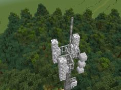 an aerial view of a tower in the middle of a forest