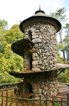 a stone tower with a roof made out of rocks