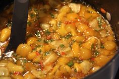 the food is being cooked in the pot on the stove top and ready to be eaten