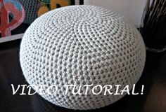 a white crocheted ball sitting on top of a table next to a framed photo