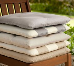 a stack of pillows sitting on top of a wooden chair