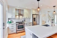 a kitchen with an island and stainless steel appliances