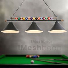 three billiards lights hanging over a pool table