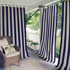 a living room with black and white striped curtains