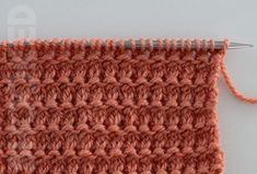 an orange crochet stitch is being worked on