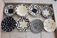 woven baskets are arranged on the floor in different shapes and sizes, including black and white