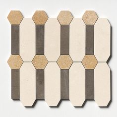 a white and brown tile wall with hexagonal shapes