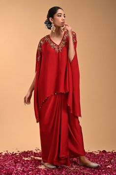 Red asymmetric tunic with floral embroidery and beaded hem. Paired with a draped dhoti style skirt. - Aza Fashions Draped Sets With Floral Embroidery In Georgette, Festive Draped Sets With Floral Embroidery, Embroidered Draped Sets For Diwali, Festive Embroidered Draped Sets, Red Georgette Kaftan For Festive Occasions, Festive Red Georgette Kaftan, Bohemian Draped Sets For Festive Occasions, Festive Bohemian Draped Sets, Red Draped Dupatta Set