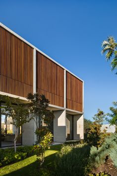 an exterior view of a building with wooden slats on the roof and side walls