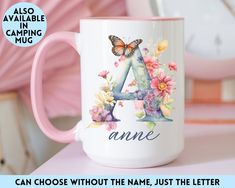 a pink and white coffee mug sitting on top of a table