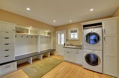 an image of a laundry room with washer and dryer on the right side