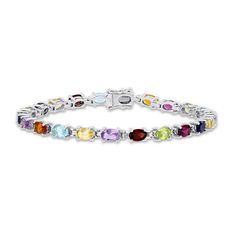 Bask in a kaleidoscope of color! With a vibrant twist on the classic tennis bracelet, you'll fall in love with a winning combination of multiple oval-cut gemstones. The array stars aquamarine, amethyst, citrine, garnet, iolite, and peridot. Fashioned in stylish sterling silver, the 7-inch bracelet secures with a box clasp. Luxury Oval Multi-stone Tennis Bracelet, Oval Multi-stone Tennis Bracelet In Fine Jewelry Style, Oval Multicolor Gemstones With Accents, Fine Jewelry Multicolor Gemstone Diamond Bracelet, Multicolor Gemstone Diamond Bracelet, Multi Gemstone Bracelet, Box Clasp, Citrine Stone, Garnet Stone