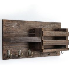 a wooden wall mounted coat rack with three hooks