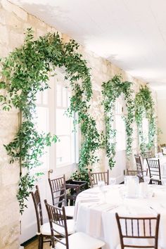 Stems Floral DesignChateau BellevueBlue Moon EventsKate Elizabeth Photography...Greenery in the Reception Area Smilax Inspiration Indoor Reception Stone Wall Light and Airy Wedding Greenery Over Doorway, Ivy Wedding Decor, Smilax Wedding, Wedding Vines, Wedding Entries, Smilax Vine, Stone Wall Light, Foliage Wedding Decor, Wedding Greenery Garland