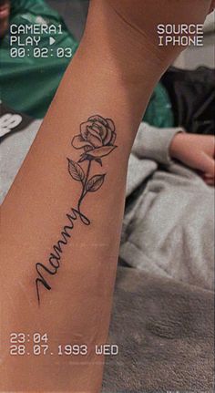 a woman's foot with a rose tattoo on her left leg and the words mama written in cursive writing