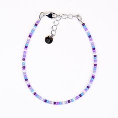 Playfully adorn your wrist with our Dainty bracelet, featuring a blend of purple, blue, and white seed beads. Bring a touch of charm to any outfit with this whimsical accessory. Materials:size 11/0 glass seed beadsbeading wiresilver plated crimp beadssilver plated wire guardssilver plated lobster claw claspsilver plated extension chainsilver plated logo charm Seed Beads Bracelet, Lavender Seeds, Purple Beaded Bracelets, Whimsical Accessories, Double Wrap Bracelet, Dainty Bracelet, Dainty Bracelets, Seed Bead Bracelets, Purple Crystals