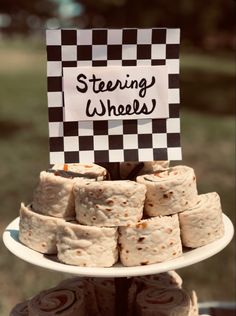 a stack of food sitting on top of a white plate next to a green field