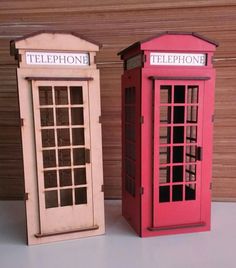 two toy telephone booths sitting next to each other