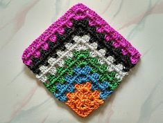 there is a crocheted square that looks like it has been made with yarn