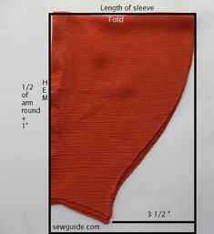 an orange piece of cloth is shown with measurements for the length of it and width