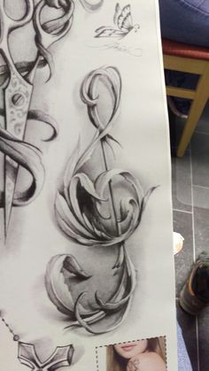 a drawing of scissors and flowers on a piece of paper