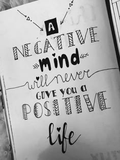 a notebook with some writing on it that says negative mind will never give you a positive life