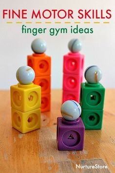 five colorful toys sitting on top of a wooden table with text overlay reading fine motor skills finger gym ideas