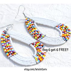 white beaded hoop earrings with multicolored beads and silver earwires on top