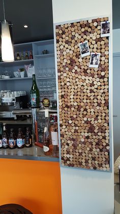 there is a cork board on the wall behind the bar counter in this small restaurant