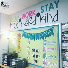 a bulletin board with words on it in the middle of an office cubicle that reads, play work stay nice and kind