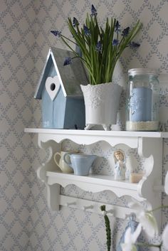 a shelf filled with blue and white items