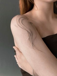 a woman with a tattoo on her arm