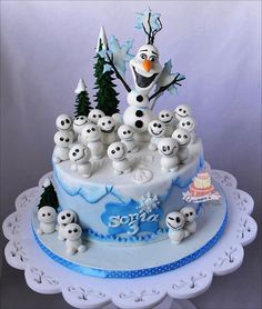 there is a cake decorated with frosting and snowmen